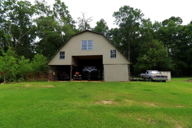 42073 Farlow Ln, Ponchatoula, LA 70454 - rear view of house featuring a barn, a detached garage, an outdoor structure, a gambrel roof, and view of scattered trees