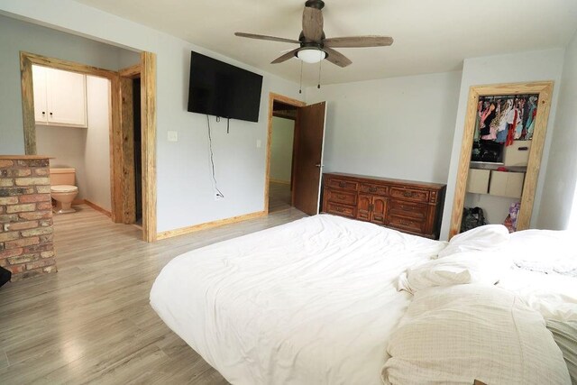 42073 Farlow Ln, Ponchatoula, LA 70454 - bedroom featuring light wood-type flooring, a closet, baseboards, a walk in closet, and ensuite bath