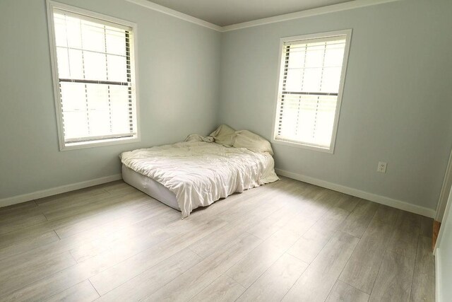 42073 Farlow Ln, Ponchatoula, LA 70454 - bedroom featuring multiple windows, baseboards, wood finished floors, and crown molding