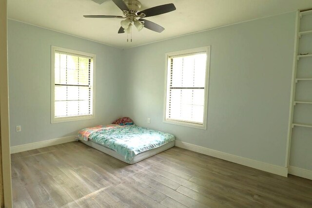 42073 Farlow Ln, Ponchatoula, LA 70454 - bedroom with baseboards, wood finished floors, and a ceiling fan