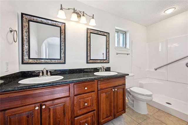 2228 Veronica Dr, Chalmette, LA 70043 - bathroom featuring toilet, tile patterned floors, double vanity, a textured ceiling, and a shower