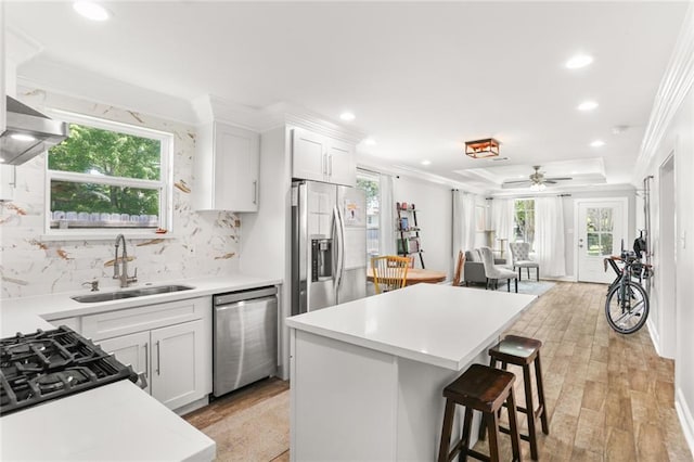 2067 Lafreniere St, New Orleans, LA 70122 - kitchen with stainless steel appliances, a sink, open floor plan, a breakfast bar, and decorative backsplash