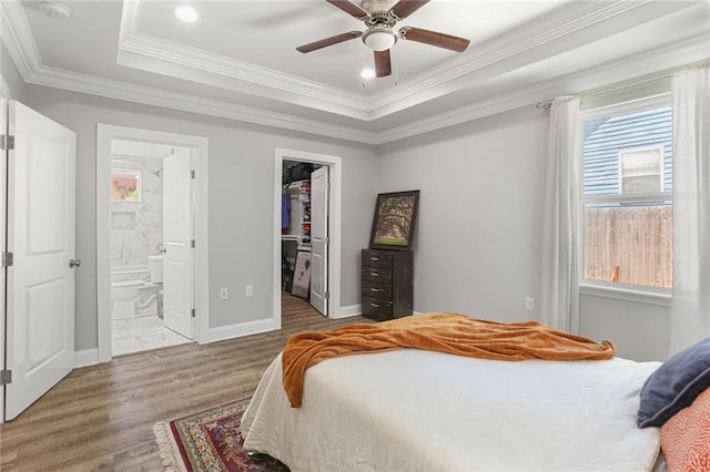 2067 Lafreniere St, New Orleans, LA 70122 - bedroom featuring multiple windows, wood finished floors, a raised ceiling, a spacious closet, and ornamental molding