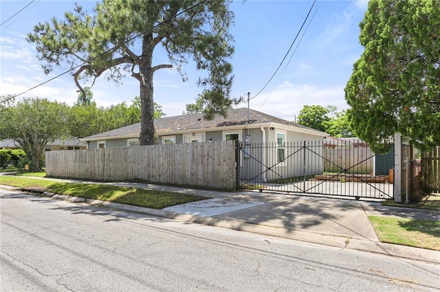 2067 Lafreniere St, New Orleans, LA 70122 - view of front of house with a gate and stucco siding