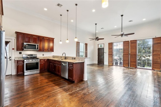 1607 N Villere St, New Orleans, LA 70116 - kitchen featuring stainless steel appliances, a peninsula, open floor plan, dark wood-style flooring, and ornamental molding