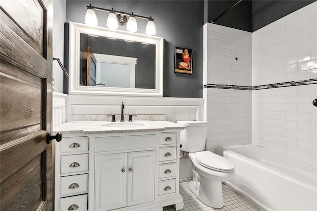 1607 N Villere St, New Orleans, LA 70116 - bathroom with toilet, vanity, tile patterned flooring, wainscoting, and shower / bathtub combination