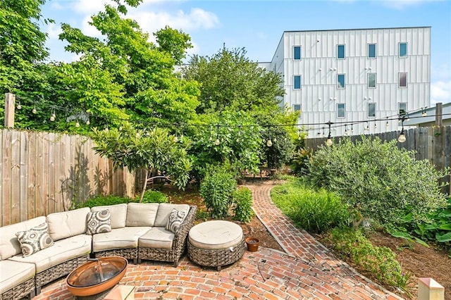 1607 N Villere St, New Orleans, LA 70116 - fenced backyard featuring an outdoor living space with a fire pit and a patio area