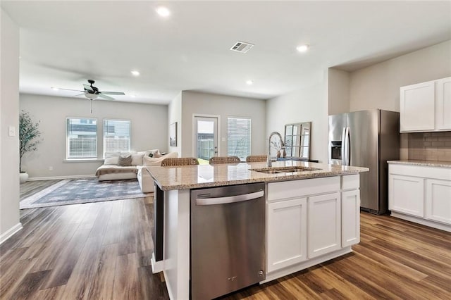 784 Bent Cypress Ln, Slidell, LA 70461 - kitchen with appliances with stainless steel finishes, a sink, open floor plan, a kitchen island with sink, and healthy amount of natural light