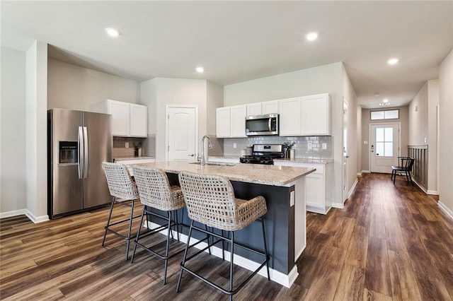 784 Bent Cypress Ln, Slidell, LA 70461 - kitchen with stainless steel appliances, a sink, tasteful backsplash, white cabinetry, and recessed lighting