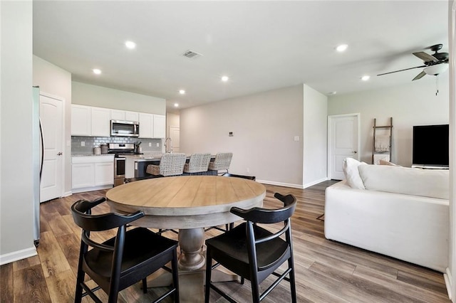 784 Bent Cypress Ln, Slidell, LA 70461 - dining space featuring a ceiling fan, wood finished floors, recessed lighting, and baseboards