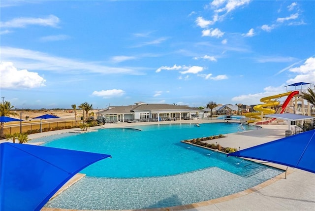 784 Bent Cypress Ln, Slidell, LA 70461 - community pool featuring a water slide and a patio area