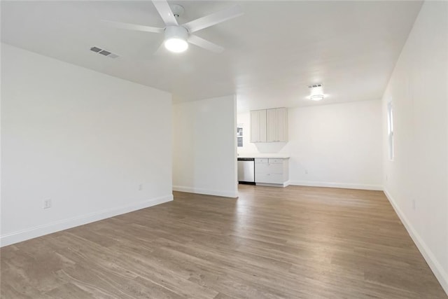 70454 B St, Covington, LA 70433 - unfurnished living room featuring a ceiling fan, baseboards, and light wood-type flooring