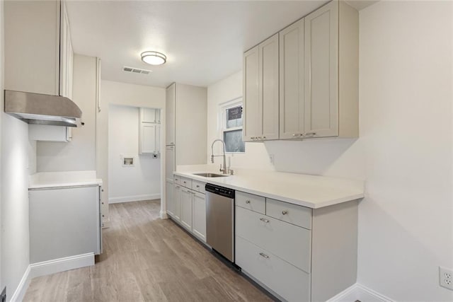 70454 B St, Covington, LA 70433 - kitchen with dishwasher, baseboards, a sink, light wood finished floors, and light countertops