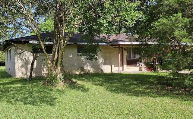 140 N 14th St, Ponchatoula, LA 70454 - back of property with a lawn, a porch, and brick siding