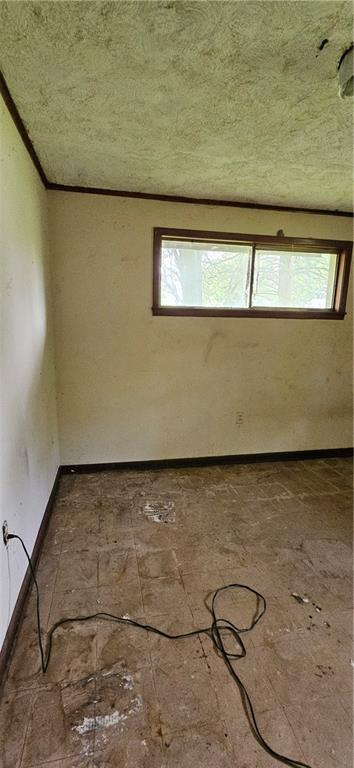 140 N 14th St, Ponchatoula, LA 70454 - spare room featuring plenty of natural light, baseboards, and a textured ceiling