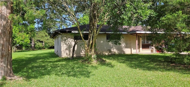 140 N 14th St, Ponchatoula, LA 70454 - view of home's exterior with a yard and brick siding