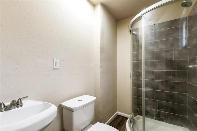 5927 Brighton Pl, New Orleans, LA 70131 - full bathroom with a sink, a stall shower, toilet, and wood finished floors