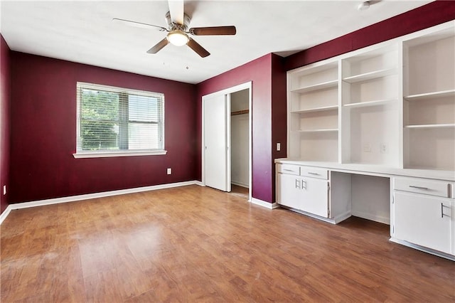 5927 Brighton Pl, New Orleans, LA 70131 - unfurnished office with a ceiling fan, light wood-style flooring, built in study area, and baseboards