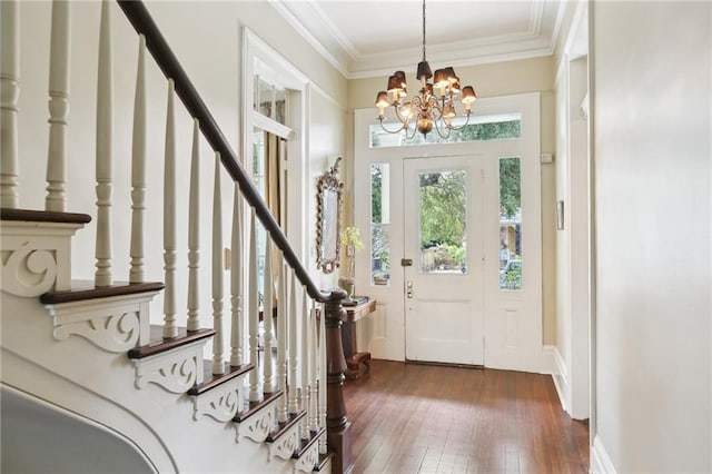 919 Robert St, New Orleans, LA 70115 - entryway featuring dark wood finished floors, ornamental molding, stairway, and a chandelier