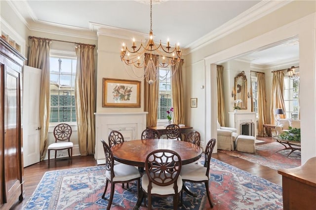 919 Robert St, New Orleans, LA 70115 - dining space with a chandelier, healthy amount of natural light, ornamental molding, wood finished floors, and a fireplace