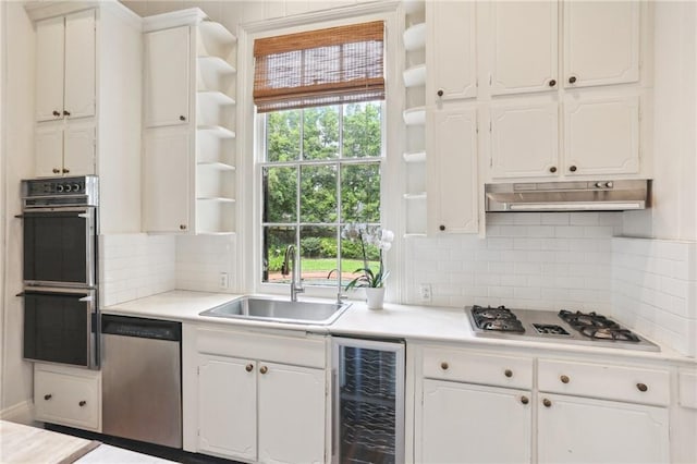 919 Robert St, New Orleans, LA 70115 - kitchen with open shelves, stainless steel dishwasher, a sink, wine cooler, and double wall oven