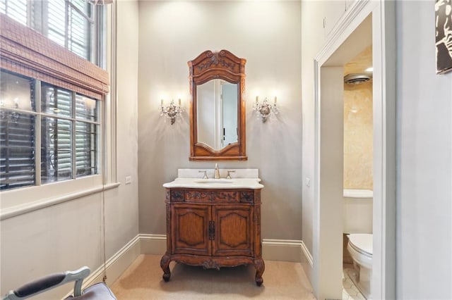 919 Robert St, New Orleans, LA 70115 - bathroom with toilet, vanity, and baseboards