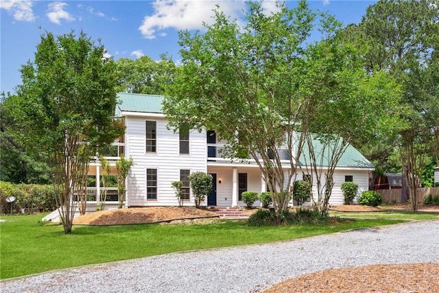 48 Bleu Lake Dr, Covington, LA 70435 - view of front of property with a balcony, a front lawn, and metal roof