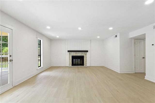 48 Bleu Lake Dr, Covington, LA 70435 - unfurnished living room featuring light wood-style floors, baseboards, a tile fireplace, and recessed lighting