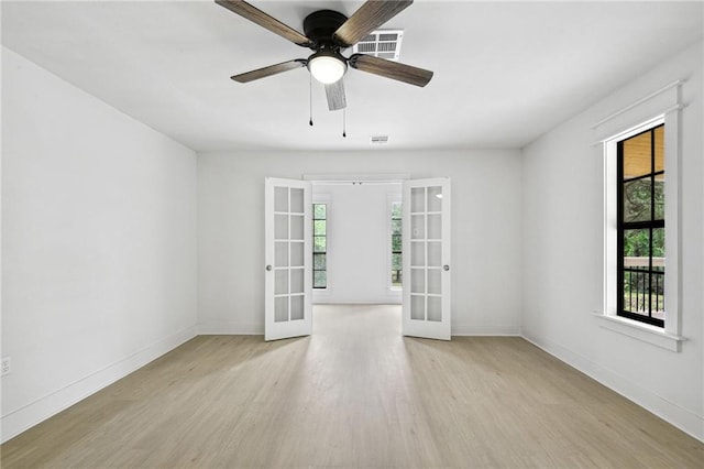 48 Bleu Lake Dr, Covington, LA 70435 - unfurnished room with french doors, wood finished floors, and plenty of natural light