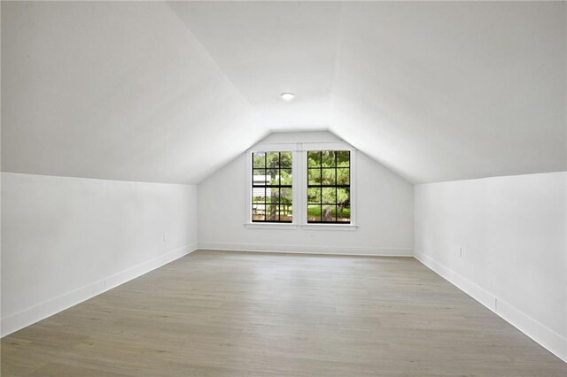 48 Bleu Lake Dr, Covington, LA 70435 - bonus room featuring vaulted ceiling, wood finished floors, and baseboards