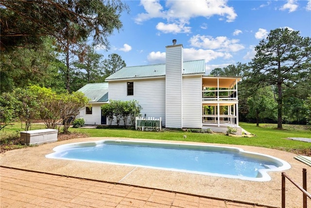 48 Bleu Lake Dr, Covington, LA 70435 - rear view of property with a balcony, metal roof, a yard, and an outdoor pool
