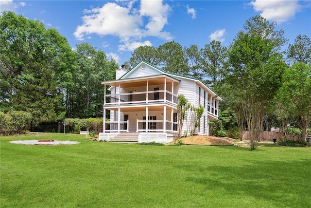 48 Bleu Lake Dr, Covington, LA 70435 - rear view of house with a balcony, a chimney, and a fire pit