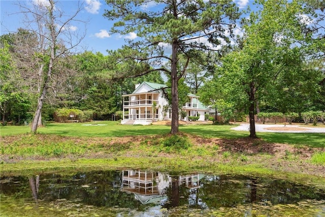 48 Bleu Lake Dr, Covington, LA 70435 - view of grassy yard with a balcony and a water view