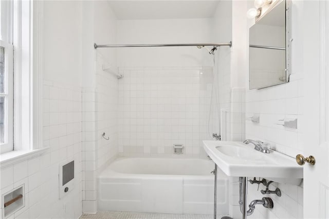 5402 St Charles Ave, New Orleans, LA 70115 - full bath with tile walls, washtub / shower combination, a sink, and tile patterned floors