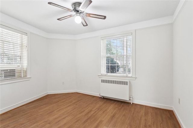 5402 St Charles Ave, New Orleans, LA 70115 - empty room featuring radiator, ceiling fan, light wood-type flooring, and baseboards