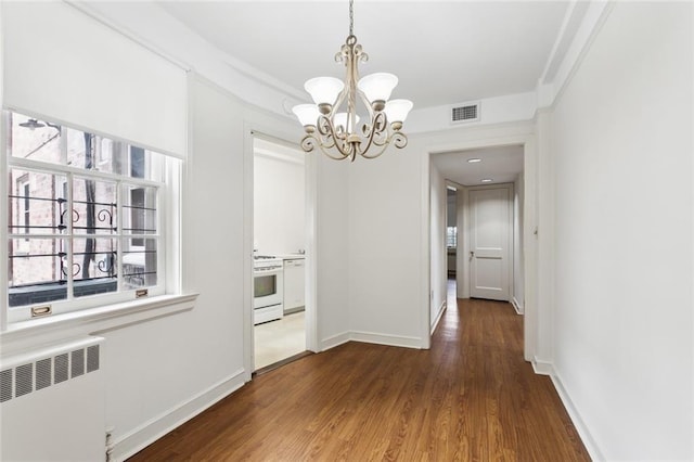 5402 St Charles Ave, New Orleans, LA 70115 - unfurnished dining area with radiator heating unit, a chandelier, wood finished floors, baseboards, and ornamental molding