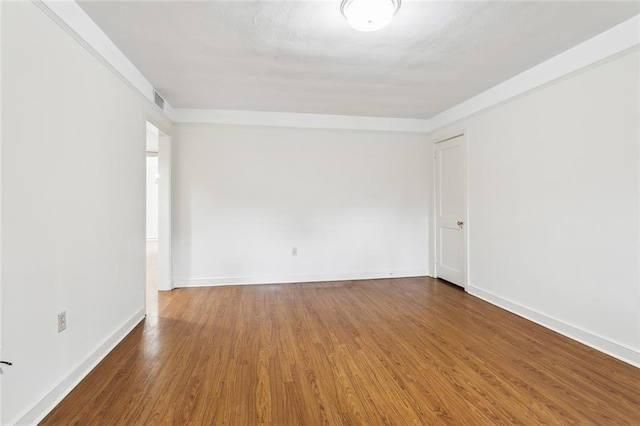 5402 St Charles Ave, New Orleans, LA 70115 - empty room with wood finished floors and baseboards