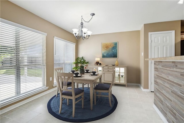 709 Bridle Ct, Covington, LA 70435 - dining space featuring a chandelier, light tile patterned floors, and baseboards