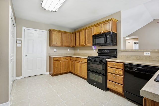 709 Bridle Ct, Covington, LA 70435 - kitchen with black appliances, light countertops, brown cabinets, and baseboards