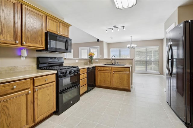 709 Bridle Ct, Covington, LA 70435 - kitchen with black appliances, a sink, brown cabinetry, and light countertops