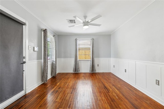 313 Harang Ave, Metairie, LA 70001 - empty room with wood-type flooring, a ceiling fan, a wainscoted wall, and ornamental molding