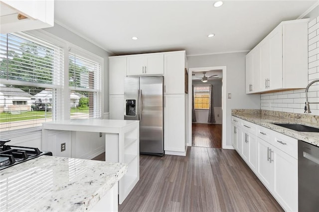 313 Harang Ave, Metairie, LA 70001 - kitchen featuring appliances with stainless steel finishes, a sink, ornamental molding, ceiling fan, and tasteful backsplash