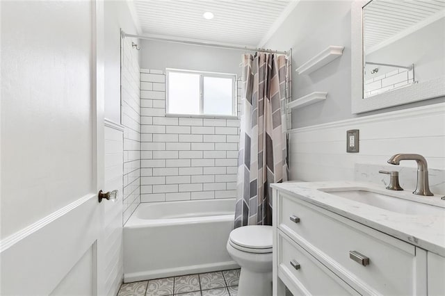 313 Harang Ave, Metairie, LA 70001 - bathroom with toilet, vanity, shower / bathtub combination with curtain, tile patterned floors, and wainscoting