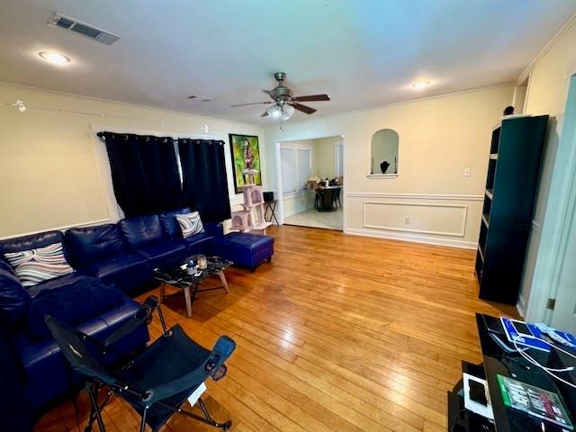 1742 4th St, Slidell, LA 70458 - living room featuring ceiling fan, hardwood / wood-style floors, and crown molding