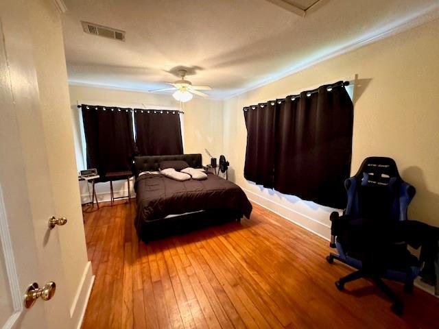 1742 4th St, Slidell, LA 70458 - bedroom featuring wood-type flooring, ceiling fan, and baseboards