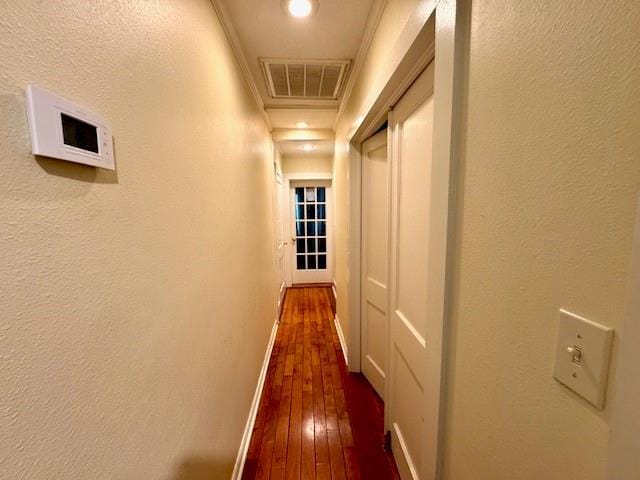 1742 4th St, Slidell, LA 70458 - hallway with dark wood-style floors, baseboards, ornamental molding, and a textured wall