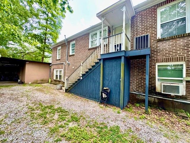 1742 4th St, Slidell, LA 70458 - view of property exterior featuring stairway and brick siding