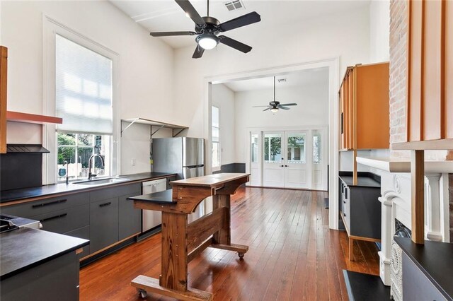 3119 Dauphine St, New Orleans, LA 70117 - kitchen featuring ceiling fan, stainless steel appliances, dark countertops, french doors, and dark wood finished floors