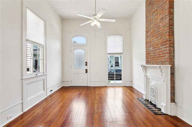 3119 Dauphine St, New Orleans, LA 70117 - entryway featuring ceiling fan, wood-type flooring, and a fireplace with flush hearth