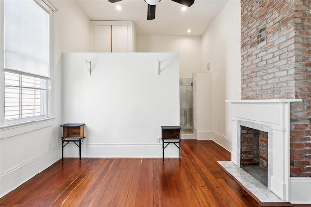 3119 Dauphine St, New Orleans, LA 70117 - miscellaneous room featuring a ceiling fan, a fireplace with flush hearth, and hardwood / wood-style floors